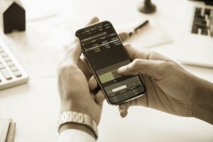 Man looking at dividend reinvestment calculator (DRIP Calculator)